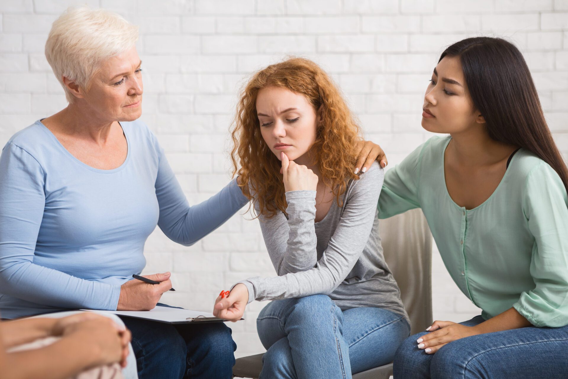 women participating in supportive group therapy session focused on shared healing and emotional recovery
